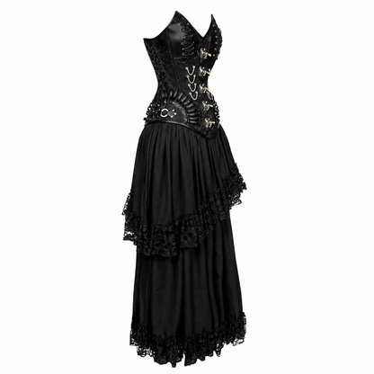 A black gothic-style long dress with a structured corset bodice, sheer mesh panels, decorative gold-toned hardware, and layered ruffled tulle skirt with lace trim, shown on a plain white background.