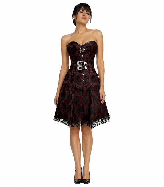 A woman modeling a strapless sweetheart corset dress with a red and black floral lace pattern and silver buckle details, set against a plain white background.