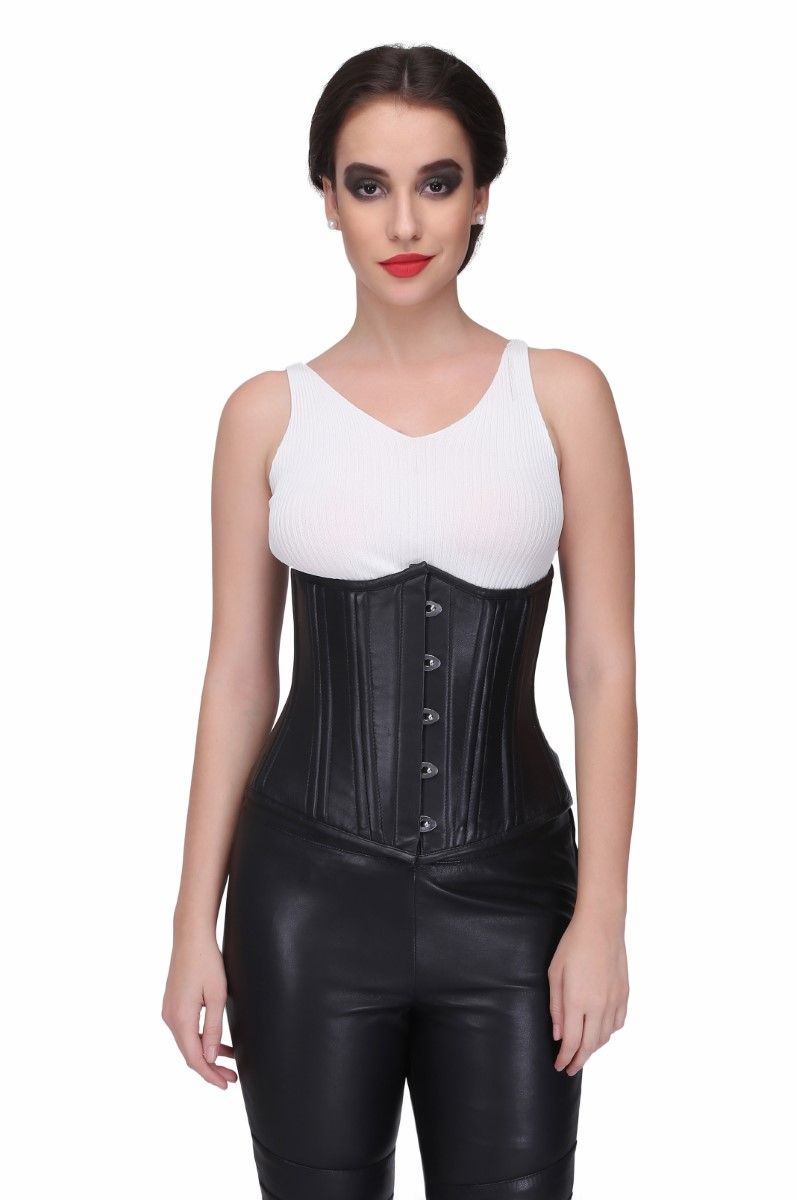 A woman wearing a black leather underbust corset with a white top and black skirt, featuring a busk front and side bones.
