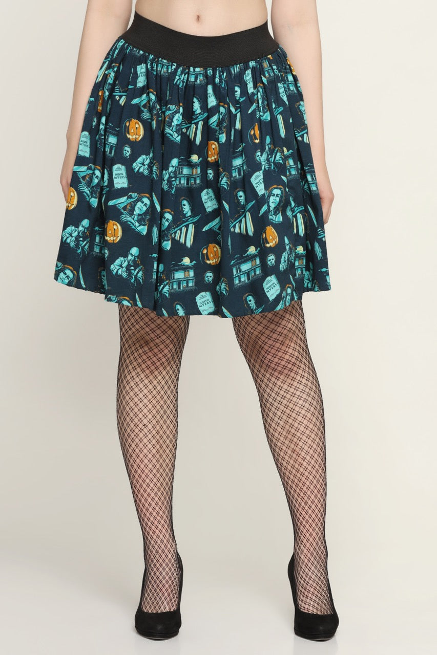 A navy-colored skirt with a printed pattern featuring various designs, paired with black fishnet stockings and high heels.