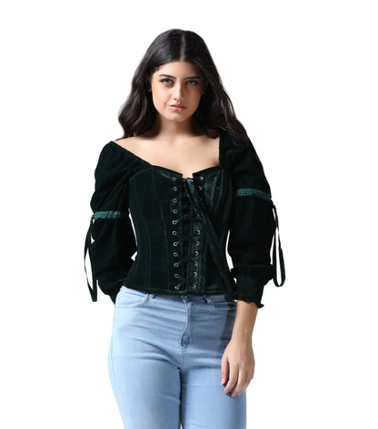 Woman wearing a dark green corset top with long sleeves and light blue jeans on a white background