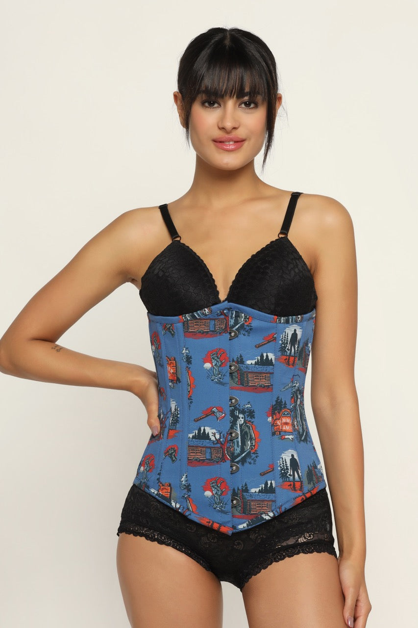 A woman wearing a blue underbust corset with a Halloween print and black lace detailing, paired with black lingerie.