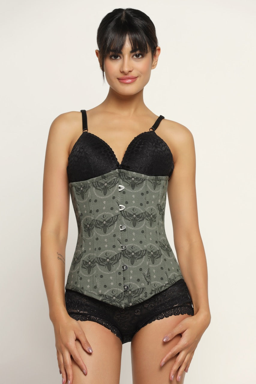 A woman wearing a paislry printed waist reducing longlined underbust corset with lace detailing and a metal busk front.