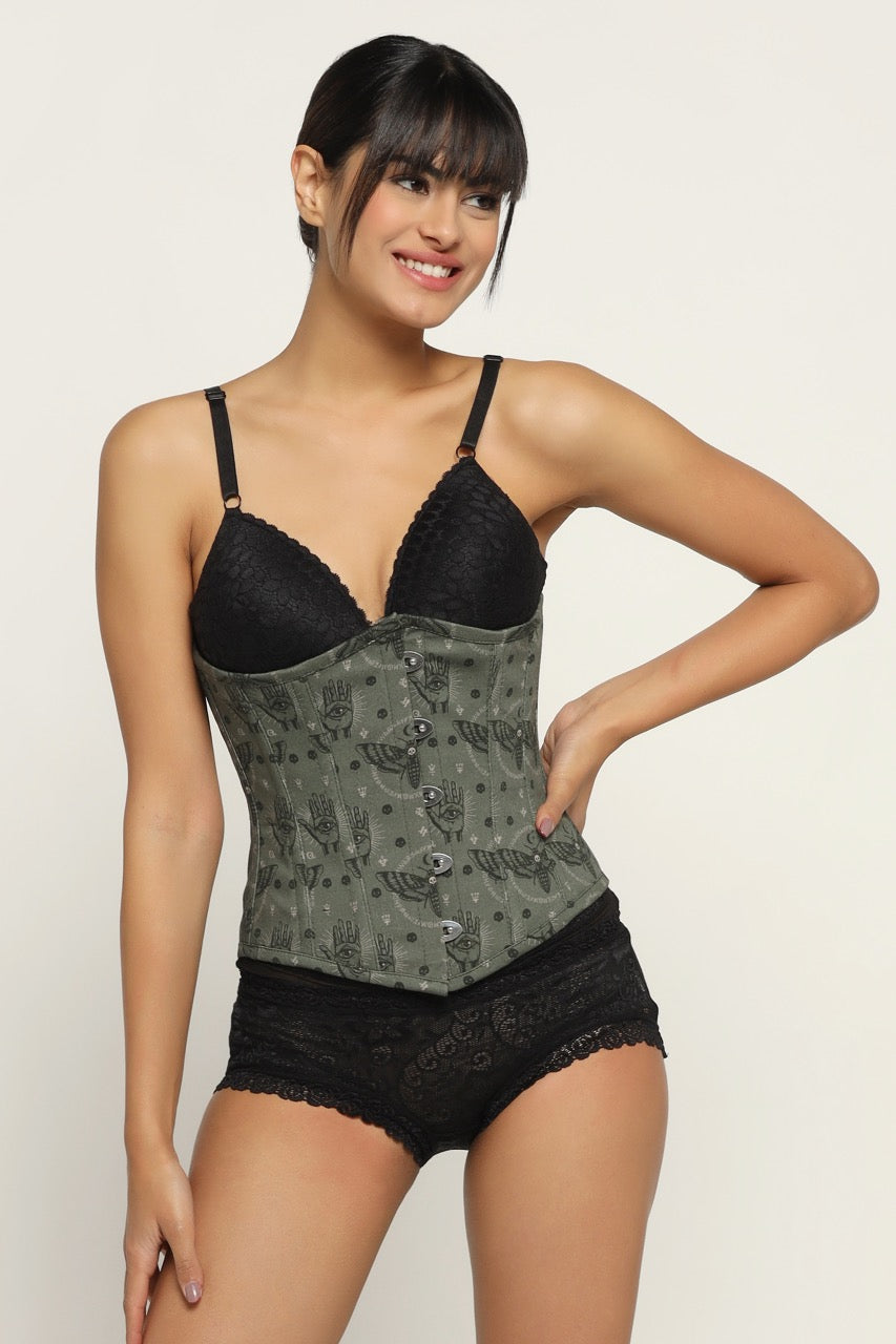 A woman wearing a bees printed waist reducing underbust corset with lace detailing and a black bra.