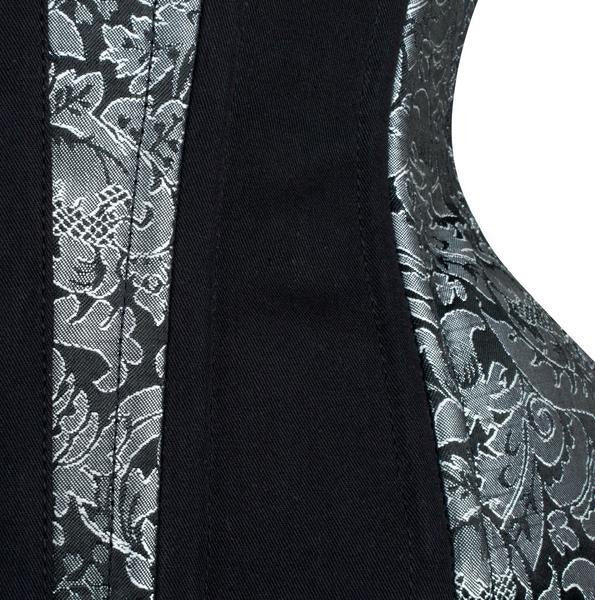 Close-up of a garment showing a black central panel flanked by black and silver damask-patterned fabric panels.