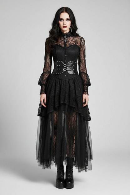 A model wearing a black gothic-style dress with sheer lace sleeves, a structured corset waist, and a layered tulle skirt, photographed against a neutral gray studio background.