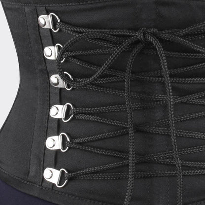 Black corset with laces and metal hooks on a white background