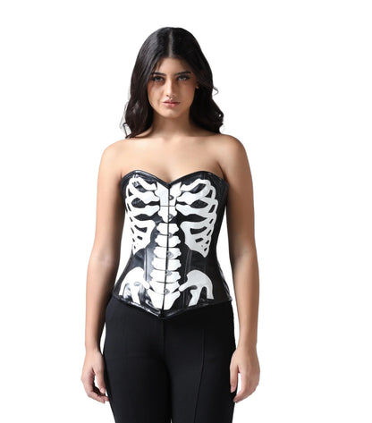 A woman modeling a glossy black latex strapless corset with a white skeleton ribcage print, paired with black pants, against a solid white background.