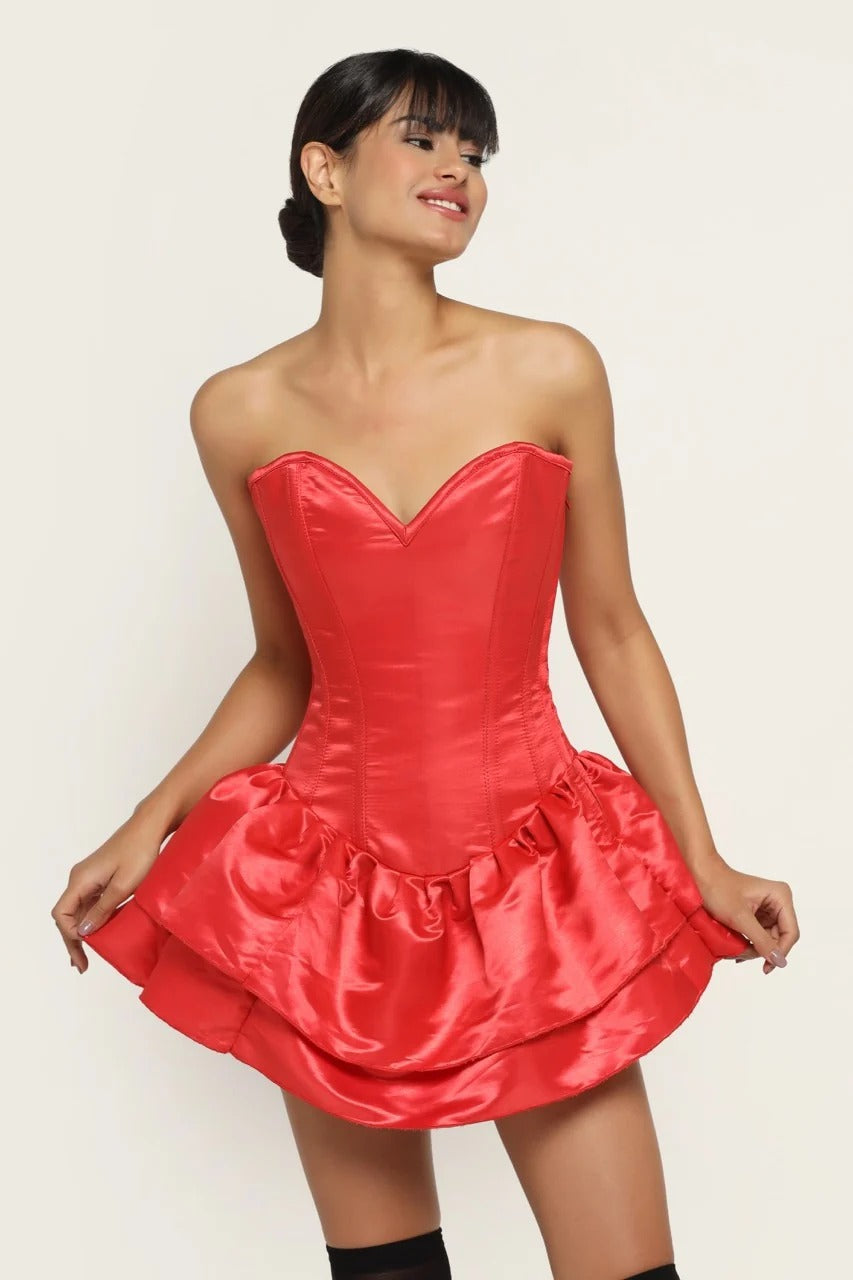 A woman modeling a bright red strapless corset mini dress with a sweetheart neckline, structured corset bodice, and ruffled tiered skirt against a plain light background.