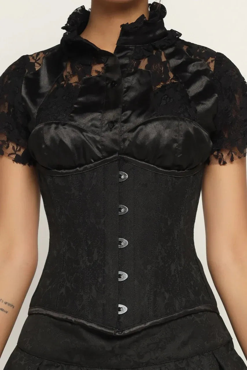 Black lace corset worn by a model on a plain background goth style corset dress