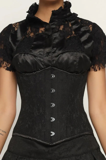 Black lace corset worn by a model on a plain background goth style corset dress